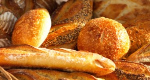 breadmaker with basket of fresh baguettes